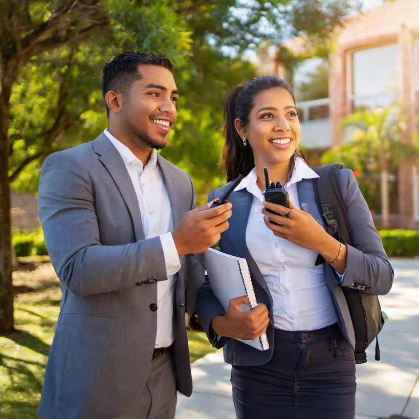 School administrators on campus with two-way radios.